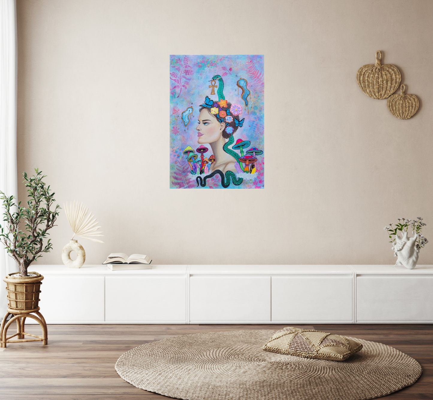 Transmutatio Divina” hanging above white low console with wicker decor, books, flowers and rattan plant pot, cozy natural interior with soft textures